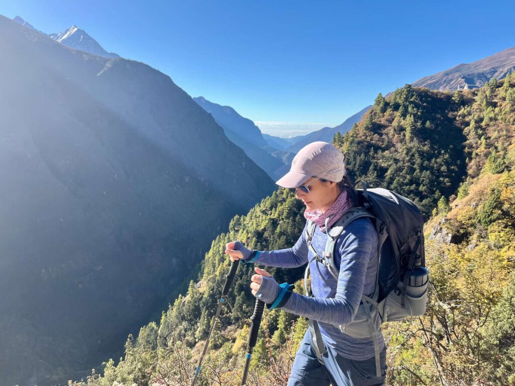 Frau beim Wandern in den Bergen als Symbol fuer Staerke und Bewaeltigung bei Fibromyalgie.